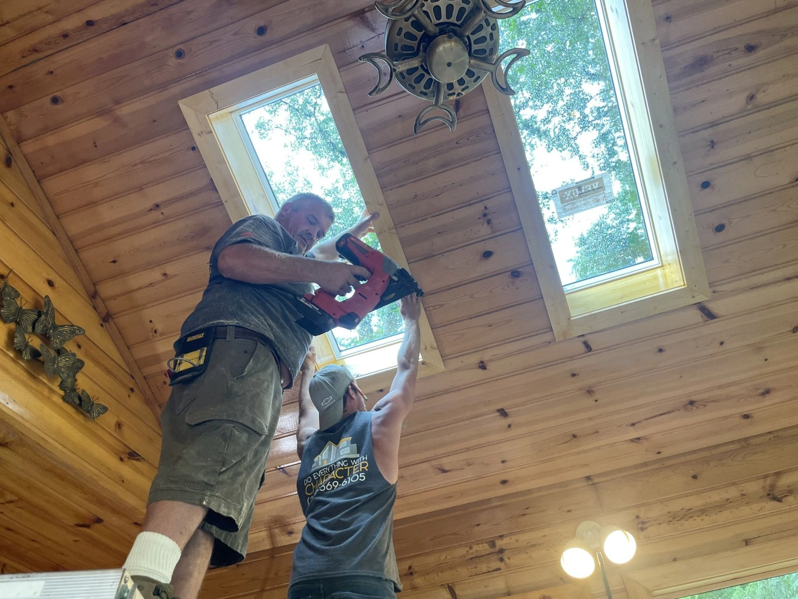 Homeowners reviewing renovation plans with contractor in updated Portage living room